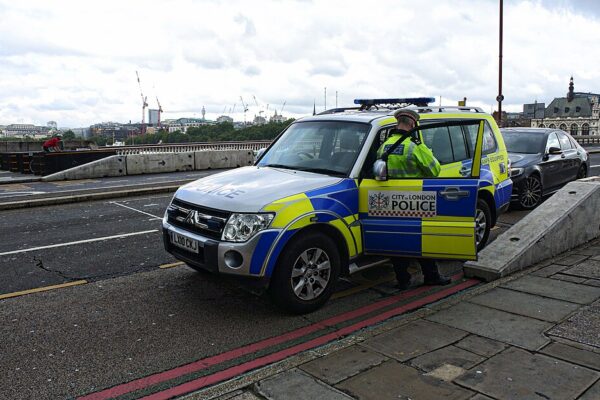 London Golders Green stabbing investigation involving City of London Police vehicle.