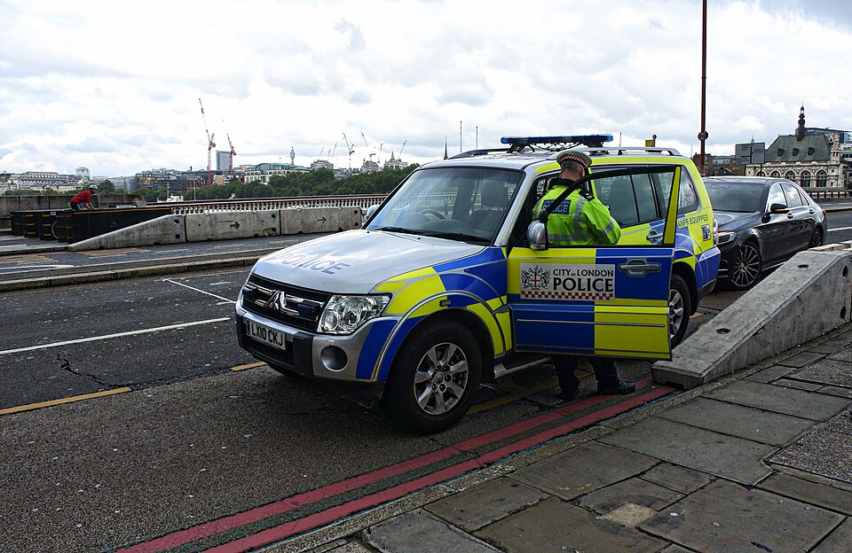 London Golders Green stabbing investigation involving City of London Police vehicle.